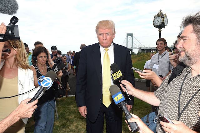 Donald Trump, at his Bronx golf course, possibly thinking about vandals with chainsaws.